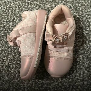 Adorable pink sneakers adorned with faux pearls and rhinestones